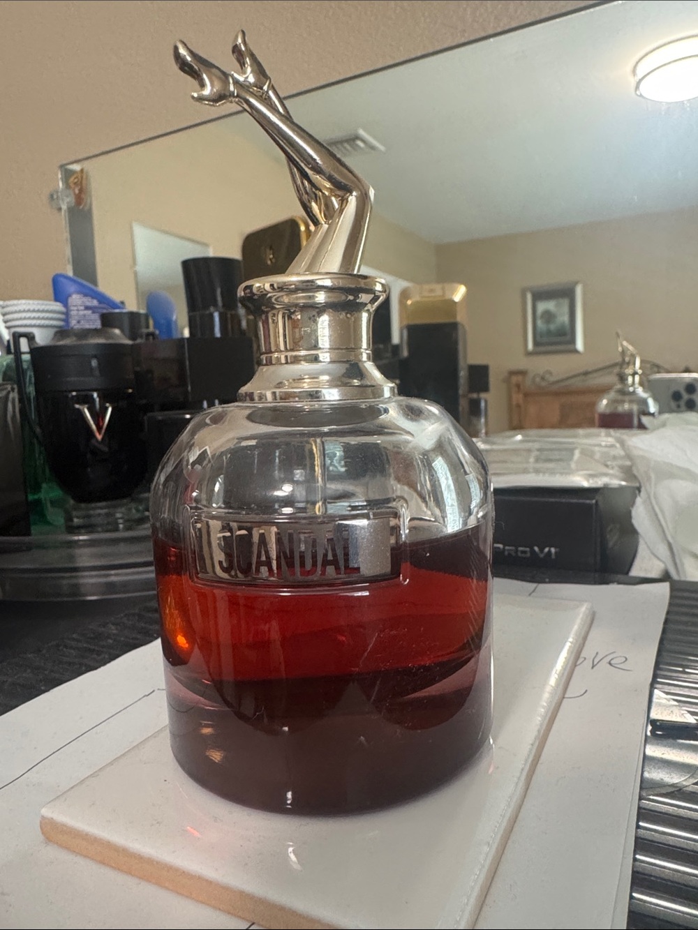 Jean Paul Gaultier Scandal by nightBottle with Gold Leg Cap and Amber-Red Liquid